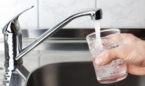Glass filled with drinking water from kitchen faucet.